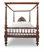 A LARGE CARVED MIXED WOOD FOUR POSTER BED, MID 19TH CENTURY