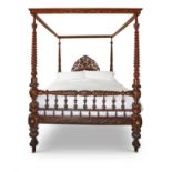 A LARGE CARVED MIXED WOOD FOUR POSTER BED, MID 19TH CENTURY