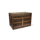 A LOUIS VUITTON CANVAS AND WOODEN BOUND TRUNK