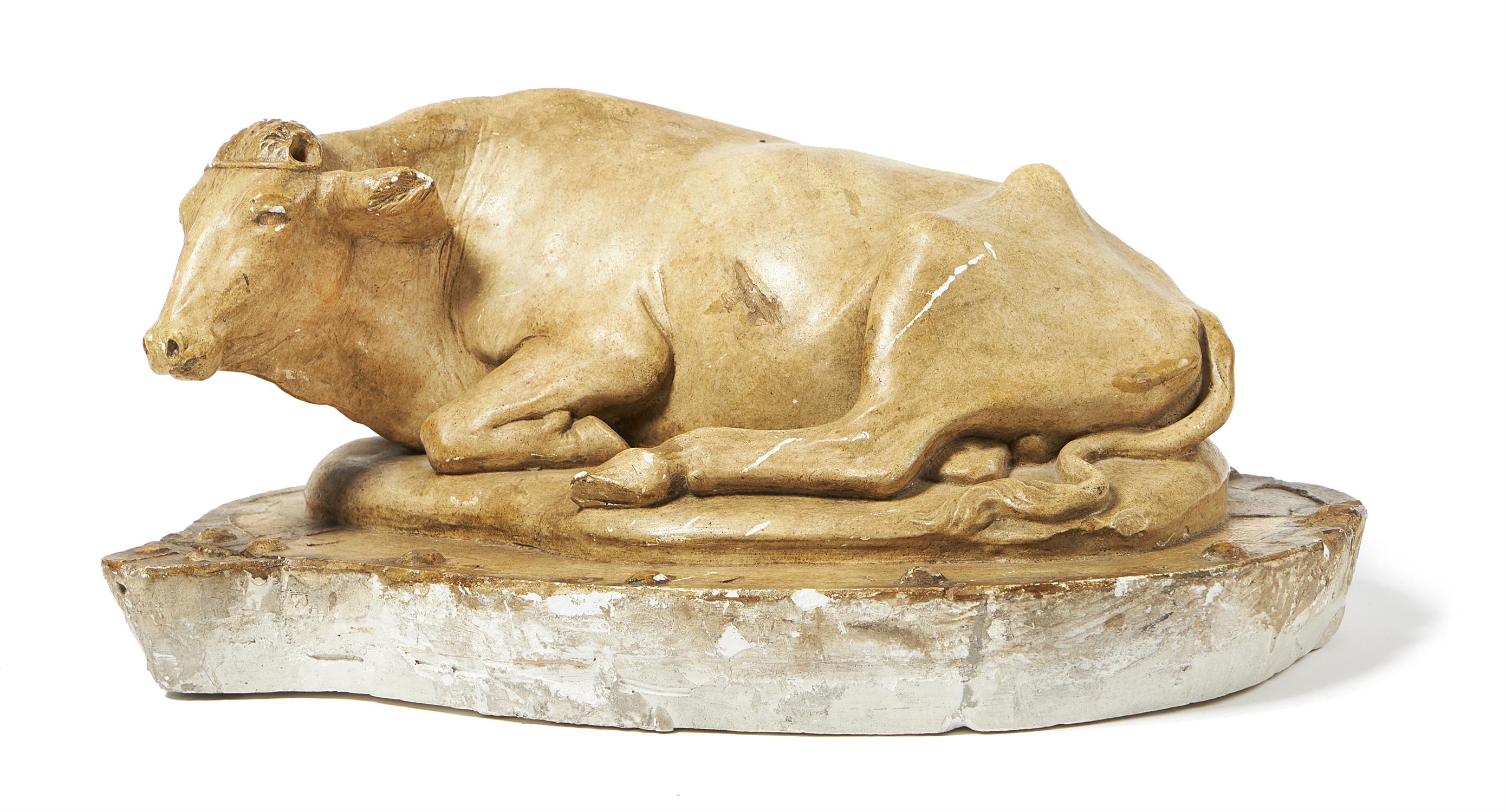 A TINTED PLASTER MODEL OF A RECUMBENT COW, POSSIBLY FRENCH