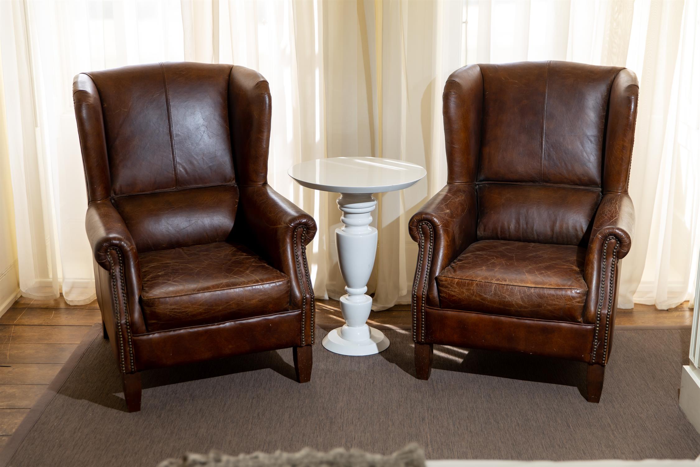 A PAIR OF LEATHER WING BACK CHAIRS, 20TH CENTURY