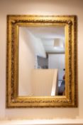 A LARGE CARVED GILTWOOD PICTURE FRAME WALL MIRROR, 19TH CENTURY