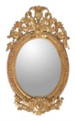 A carved giltwood and composition oval wall mirror in George III style