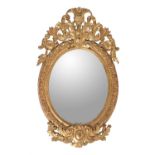 A carved giltwood and composition oval wall mirror in George III style