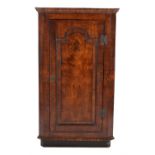 A walnut standing corner cupboard