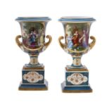 A pair of blue ground and gilt Vienna style Campana urns on plinth bases