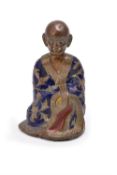 A Chinese gilt bronze and champlevé enamel figure of luohan