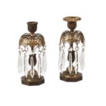 A pair of Regency parcel gilt and patinated bronze lustre candlesticks