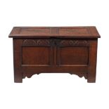 A carved oak two panel coffer