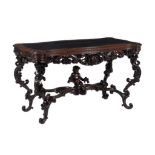 An Italian carved walnut library or centre table