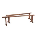 A pair of cherry trestle benches
