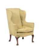 A mahogany and upholstered wing armchair