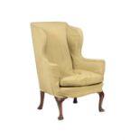 A mahogany and upholstered wing armchair