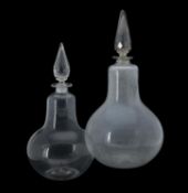 Two similar clear glass pear-shaped chemist's bottles and facetted spire stoppers