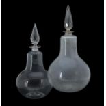 Two similar clear glass pear-shaped chemist's bottles and facetted spire stoppers