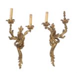 A pair of gilt metal twin light wall appliques in Louis XV style