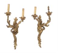 A pair of gilt metal twin light wall appliques in Louis XV style