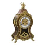 Y A red tortoiseshell and brass inlaid 'Boulle' mantel clock