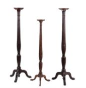 A pair of mahogany torchere stands in George III style