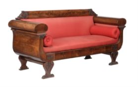 An Empire flame mahogany and upholstered sofa