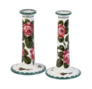 Two similar Wemyss style Abbotsford Ware tapered cylindrical candlesticks painted with cabbage roses