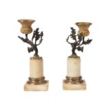 A pair of Regency gilt and patinated bronze and alabaster mounted candlesticks