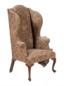 A George III oak and upholstered wing armchair