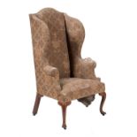 A George III oak and upholstered wing armchair