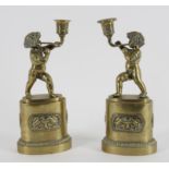 A pair of early 19th century French brass candlesticks
