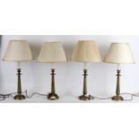 A modern set of four brass column table lights