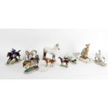 A collection of pottery and porcelain horse models