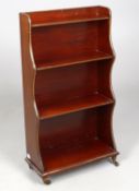 A early 20th century mahogany and gilt metal mounted open small waterfall bookcase