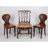 A pair of early Victorian mahogany shell back hall chairs