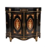 An ebonised and inlaid gilt metal mounted serpentine side cabinet,