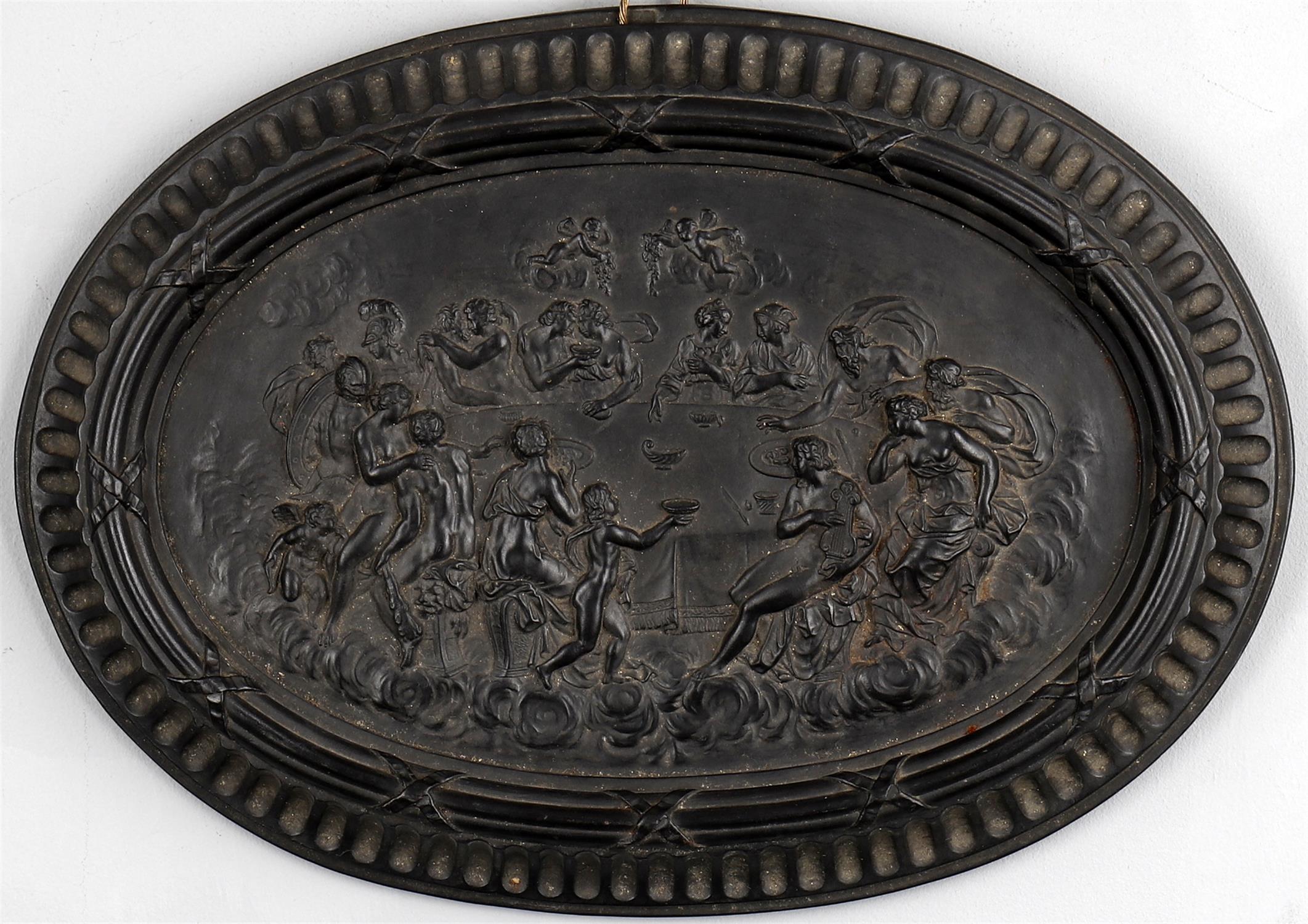 A black basalt plaque depicting the 'Feast of the Gods'