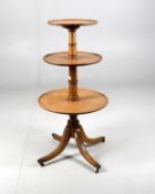 A mahogany three tier dumb waiter