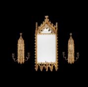 A Gothic Revival carved giltwood mirror and pair of matching girandoles