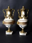 A pair of black and amber veined marble and gilt metal mounted ornamental urns in Louis XVI style