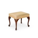 A George III mahogany and upholstered stool