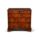 A George I walnut, burr walnut and feather banded chest of drawers