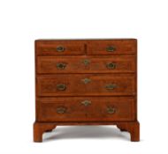 A George II walnut, burr walnut and feather banded chest of drawers