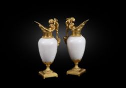 A pair of French white marble and gilt bronze mounted ewers in Louis XVI style