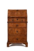 A George I walnut and feather banded bureau