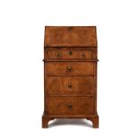 A George I walnut and feather banded bureau