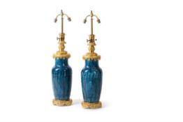 A pair of French gilt metal mounted and turquoise glazed baluster vases