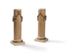A pair of French parcel-gilt and cream-painted stop-fluted column pedestals