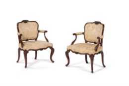 A pair of George III mahogany and upholstered open armchairs