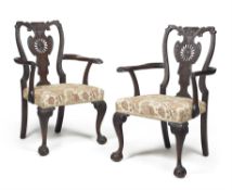 A pair of carved mahogany armchairs, in George II style, 19th century