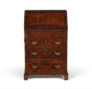 A George I walnut and feather banded bureau