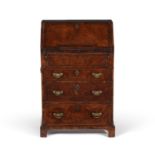 A George I walnut and feather banded bureau